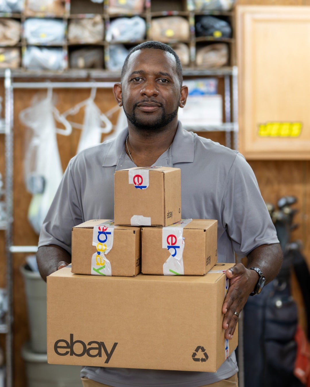 eBay seller holding boxes ready for shipment.