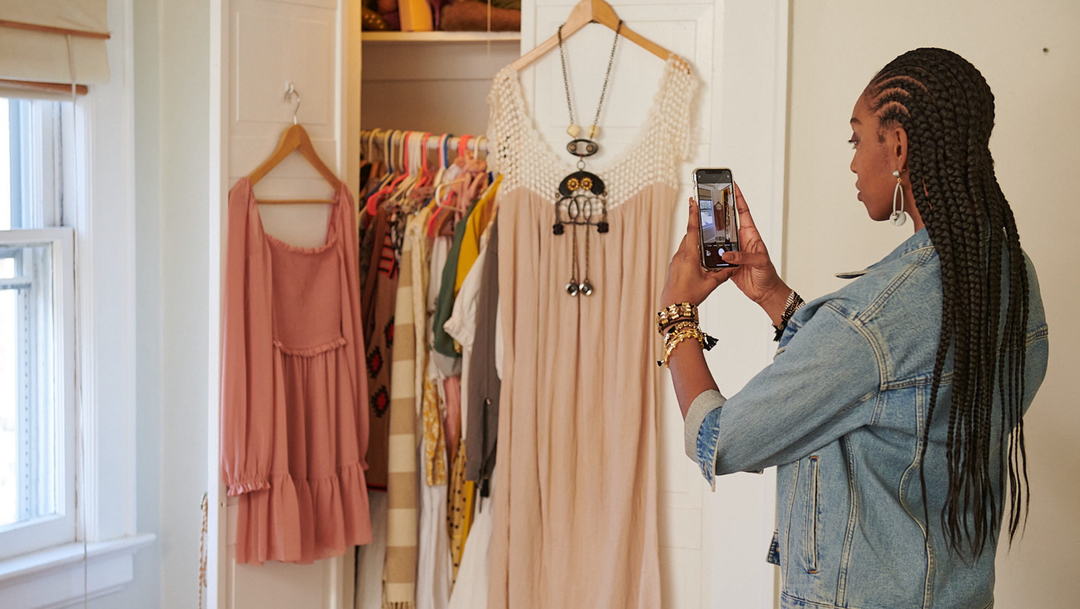 eBay seller taking a photo of a vintage dress.