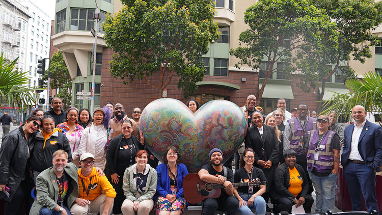 A group photo of staff, volunteers, and supporters of GLIDE.