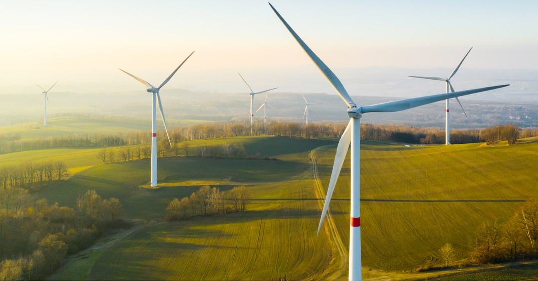 Several wind turbines on a sunny day.